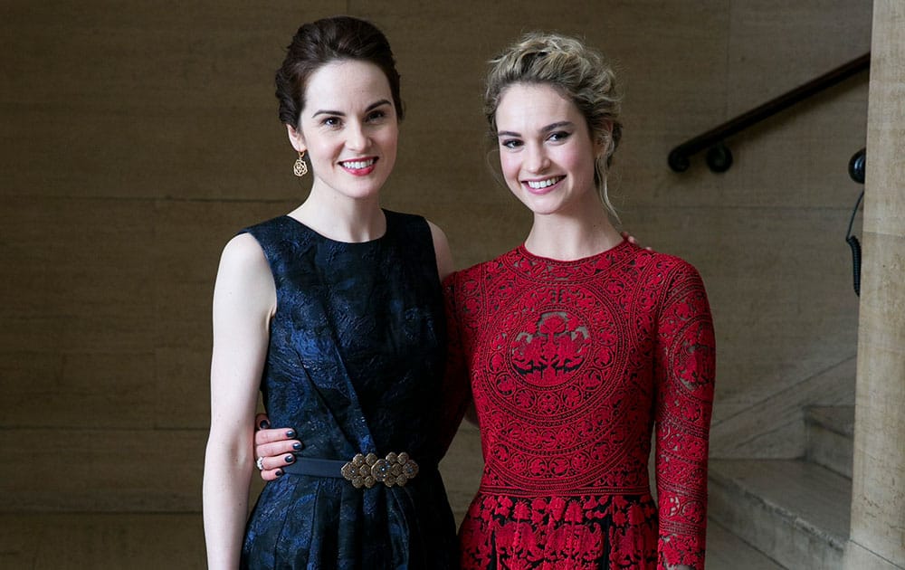 British Actresses Michelle Dockery and Lily James pose for photographers as they arrive for the Changing Faces Gala Dinner, in London.