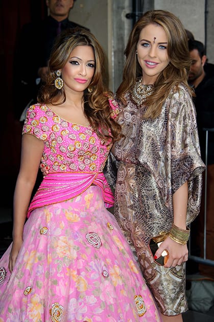 British presenter Tasmin Lucia Khan, left, and British actress Lydia Bright arrive for the Asian Awards at a central London venue, London.