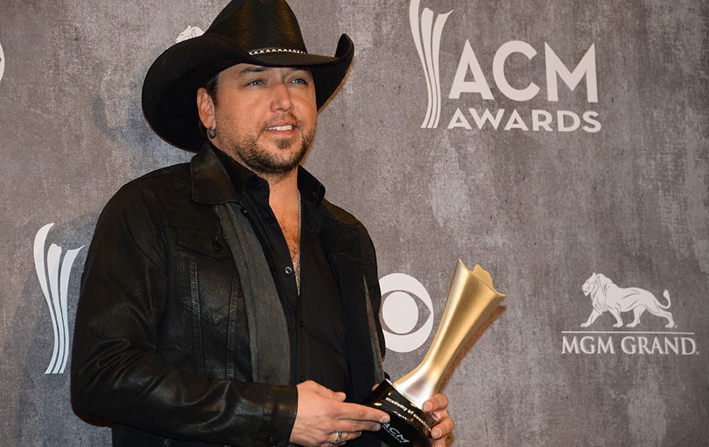 Jason Aldean poses in the press room with the award for male vocalist of the year at the 49th annual Academy of Country Music Awards at the MGM Grand Garden Arena in Las Vegas.