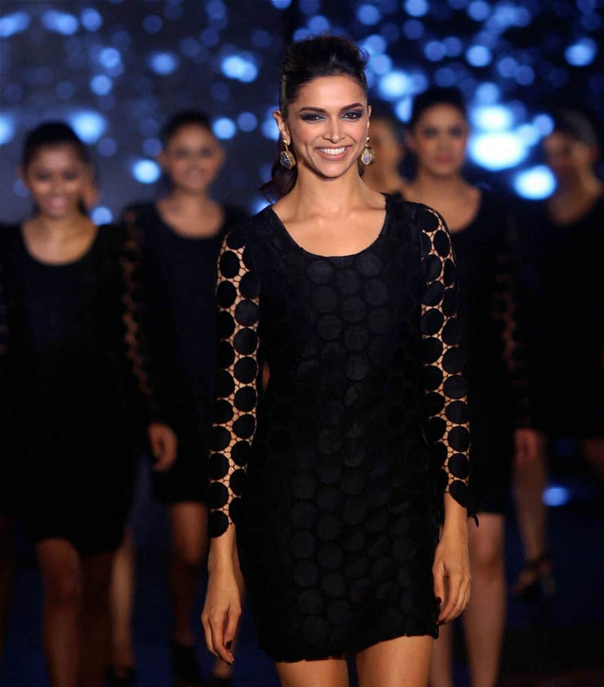 Deepika Padukone walks the ramp with her fans to showcase a designer outfit in Mumbai.