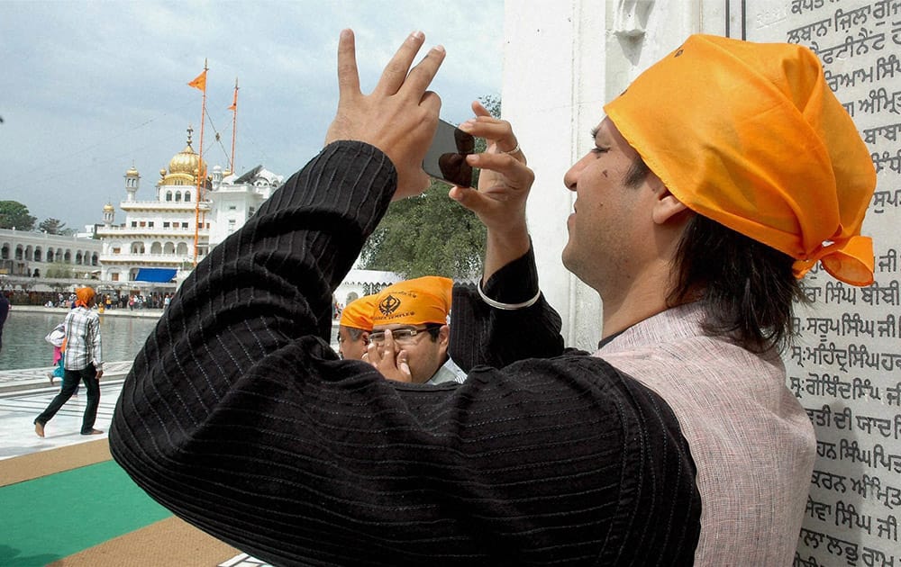 Vivek Oberoi taking pictures at the Golden Temple in Amritsar.