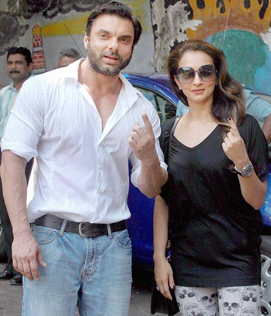 Bollywood actor Sohail Khan along with his wife, displays their inked fingers after casting their votes for Lok Sabha polls in Mumbai.
