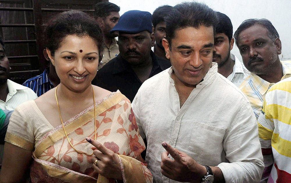 Actor Kamal Haasan and his wife Gowdami show their inked fingers after casting votes for the Lok Sabha elections, in Chennai.