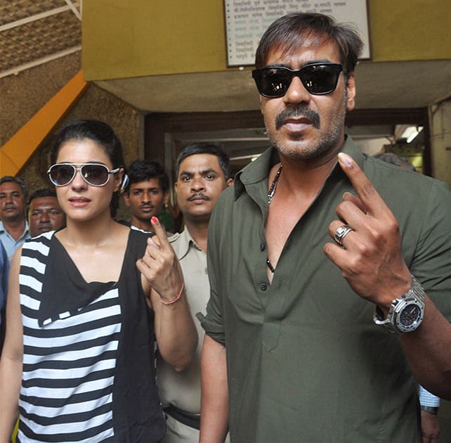Bollywood actors Ajay Devgn with wife Kajol after casting their votes during the Lok Sabha elections 2014 in Mumbai.