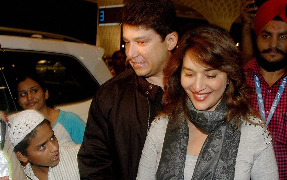 Madhuri Dixit with her husband Sriram Nene departs from Mumbai's CST International Airport for Florida, USA to take part in IIFA 2014 awards ceremony.