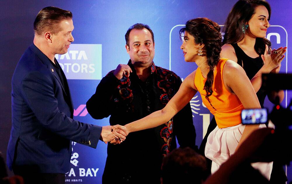 Priyanka Chopra shakes hands Hollywood star Stephen Andrew Baldwin as Pakistani Sufi singer Ustad Rahat Fateh Ali Khan looks on at International Indian Film Academy (IIFA) function in Florida, US.