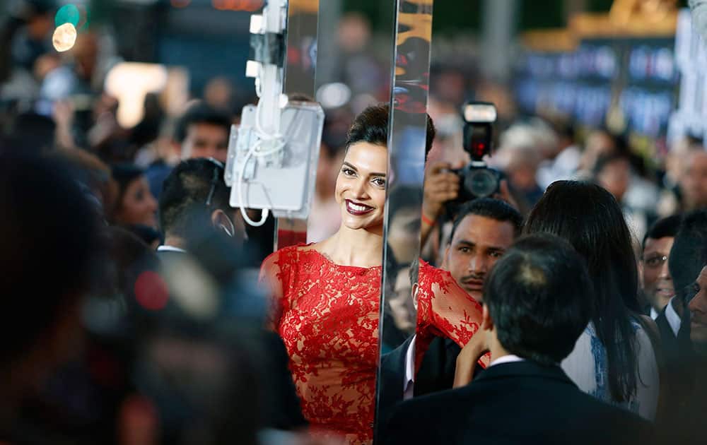 Deepika Padukone walks the green carpet as she arrives for the 15th annual International Indian Film Awards in Tampa, Fla.