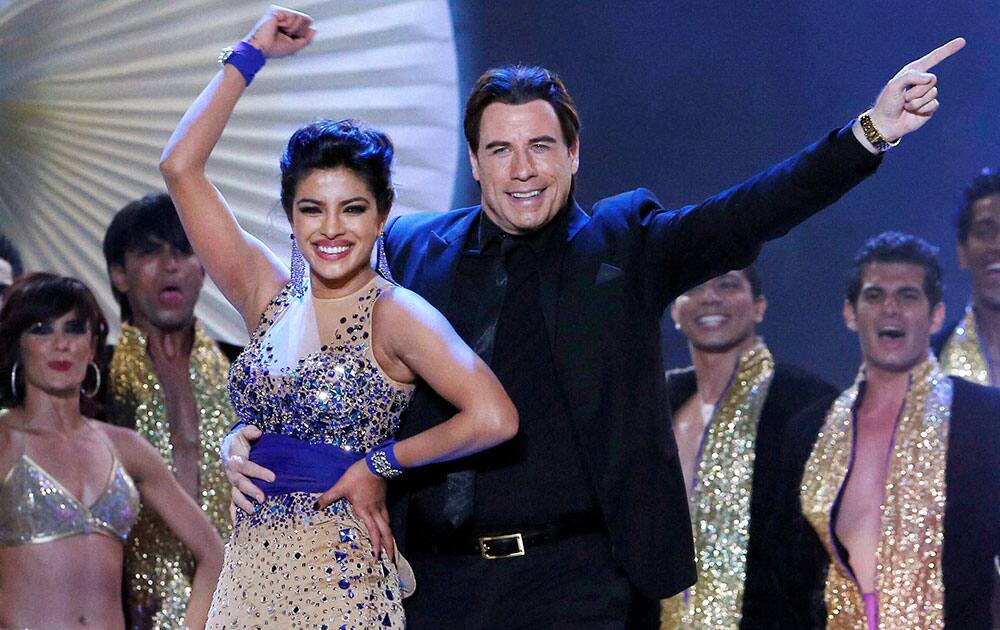 Hollywood star John Travolta dances with Bollywood actress Priyanka Chopra at the 15th IIFA Awards in Tampa.