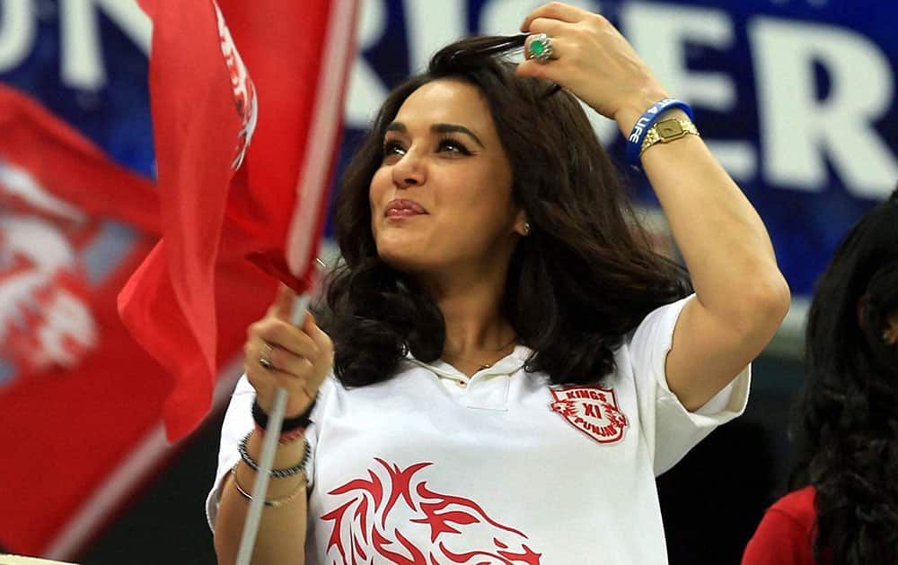 Preity Zinta co-owner of Kings XI Punjab watches her team's match against Royal Challengers Bangalore in Dubai.