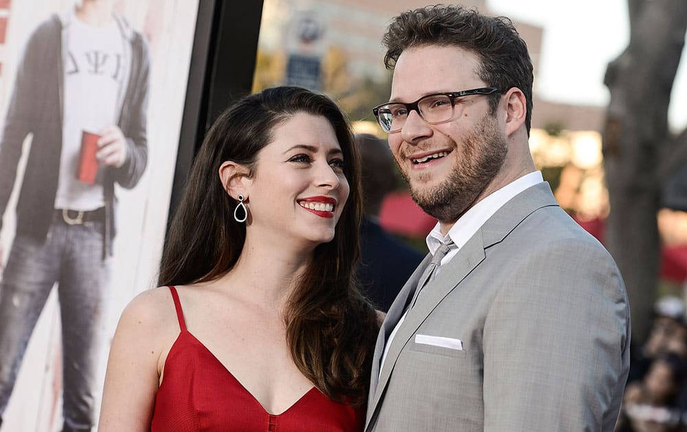 Actor Seth Rogen, right, and his wife Lauren Miller attend the premiere of the feature film `Neighbors`in Los Angeles. 