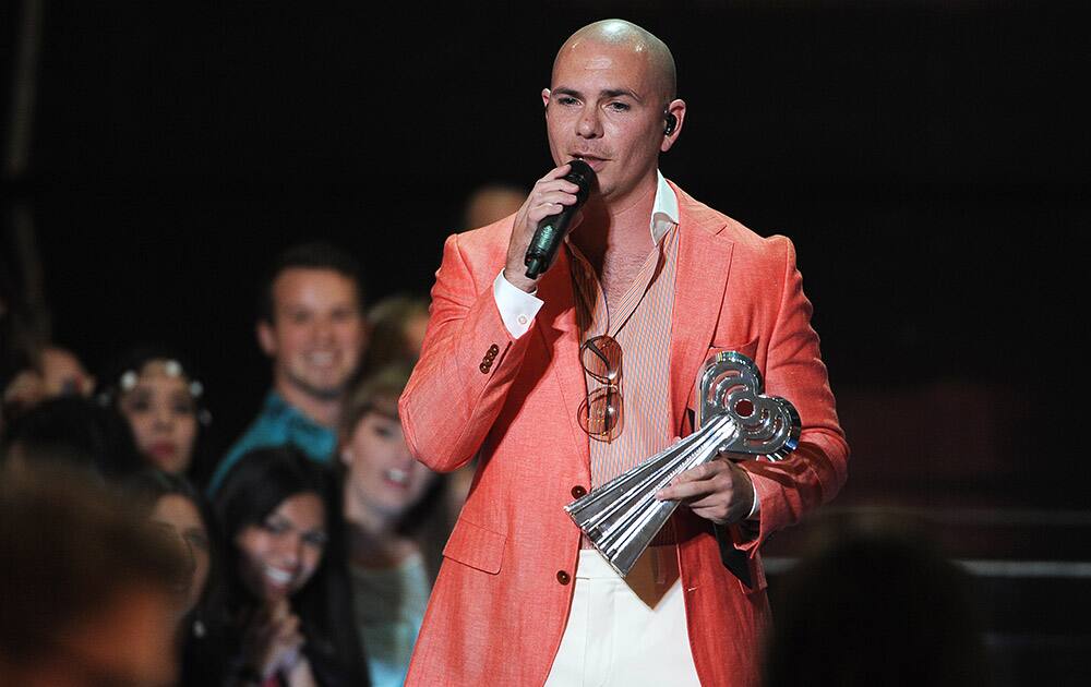 Pitbull presents the award for hip hop/R&B song of the year at the iHeartRadio Music Awards at the Shrine Auditorium in Los Angeles.