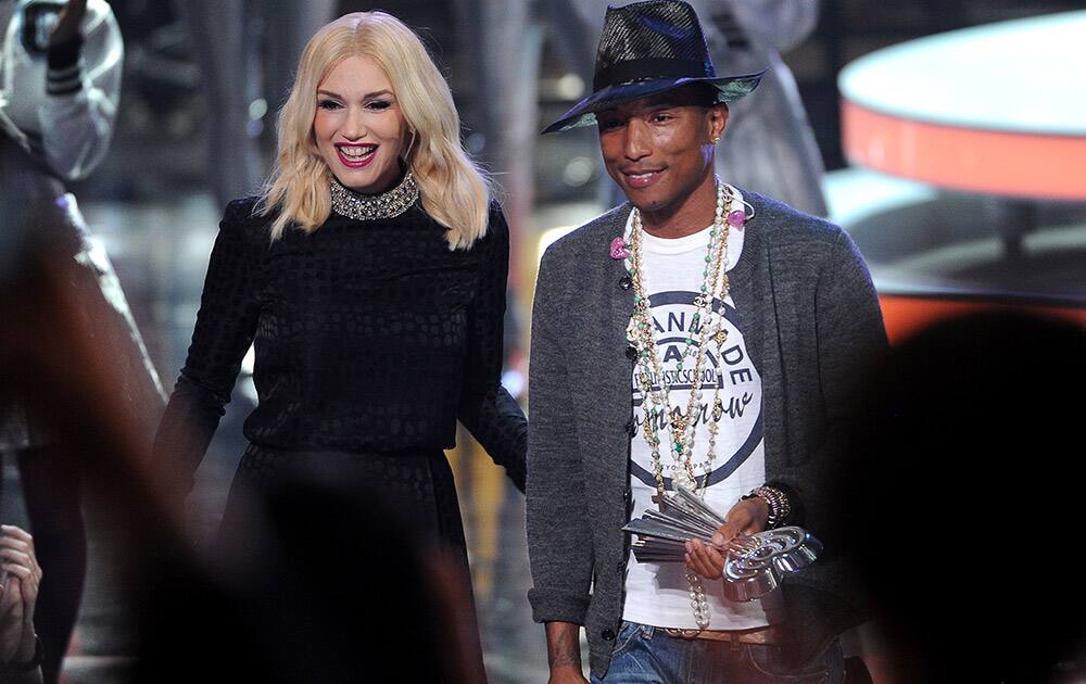 Gwen Stefani, left, presents the award for iHeartRadio innovator to Pharrell Williams at the iHeartRadio Music Awards at the Shrine Auditorium in Los Angeles.