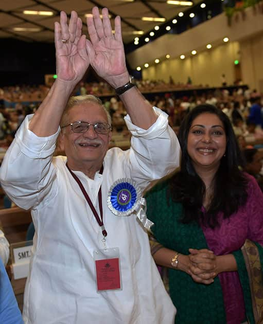 Dadasaheb Phalke Award winner Film-maker,Lyricist and author Gulzar gestures as his daughter Meghna Gulzar looks on during the 61st National Film Awards 2013 function in New Delhi.