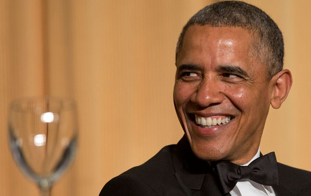 President Barack Obama laughs as actor and comedian Joel McHale speaks during the White House Correspondents' Association (WHCA) Dinner at the Washington.