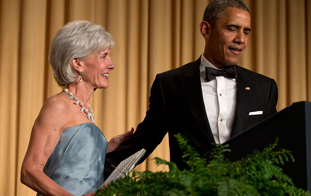 President Barack Obama, right, has outgoing Health and Human Services Secretary Kathleen Sebelius come on stage as part of a joke to fix a technical glitch at the end of his speech during the White House Correspondents' Association (WHCA) Dinner at the Washington Hilton Hotel.