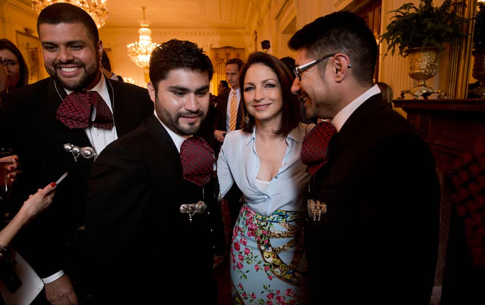 Singer Gloria Estefan, center, from Miami, with members of Mariachi band, Los Gallos Negros, at a celebration of Cinco de Mayo in the East Room of the White House in Washington.