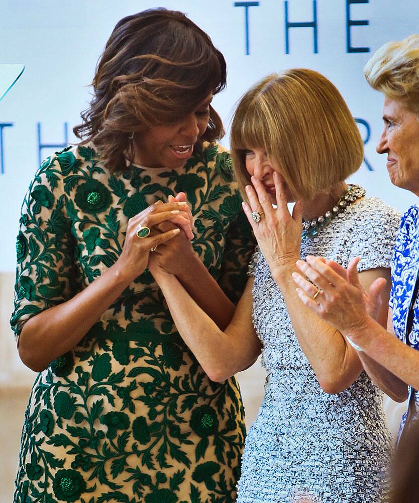 Michelle Obama, left, takes honoree Anna Wintour's hand at a dedication ceremony for the Anna Wintour Costume Center, at the Metropolitan Museum of Art in New York.