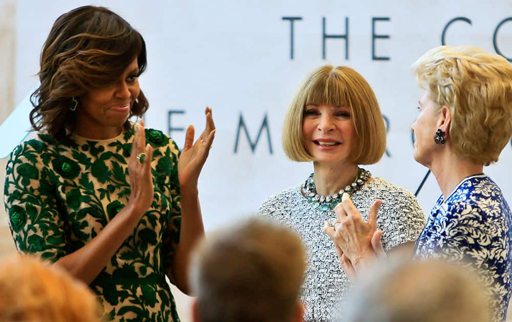 First lady Michelle Obama, left, and Metropolitan Museum of Art president Emily Rafferty, right, applaud Vogue editor Anna Wintour at a dedication ceremony for the Anna Wintour Costume Center, at the Metropolitan Museum of Art in New York.