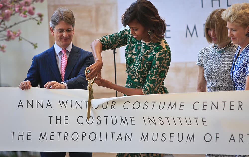 Vogue editor Anna Wintour, Metropolitan Museum director Thomas Campbell and museum president Emily Rafferty, looks on as first lady Michelle Obama cuts the ribbon at a dedication ceremony for the Anna Wintour Costume Center, at the Metropolitan Museum of Art in New York.