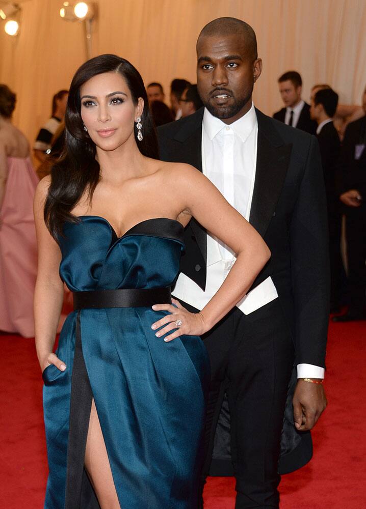 Kim Kardashian, left, and Kanye West attend The Metropolitan Museum of Art's Costume Institute benefit gala celebrating `Charles James: Beyond Fashion`in New York. 