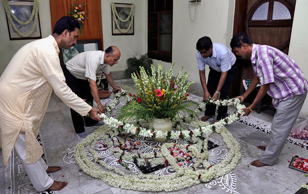 Visitors place floral garlands in front of portraits of Indian Nobel laureate Rabindranath Tagore as they pay tribute to him on his birth anniversary in Kolkata.