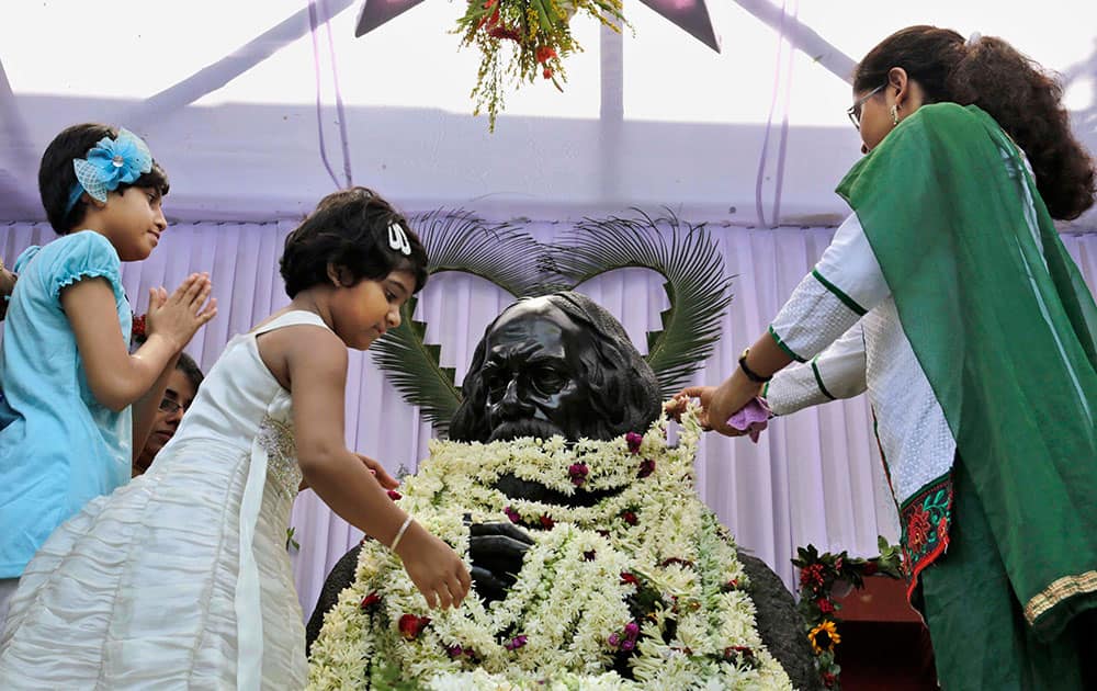 Visitors garland a statue of Indian Nobel laureate Rabindranath Tagore as they pay tribute to him on his birth anniversary in Kolkata.