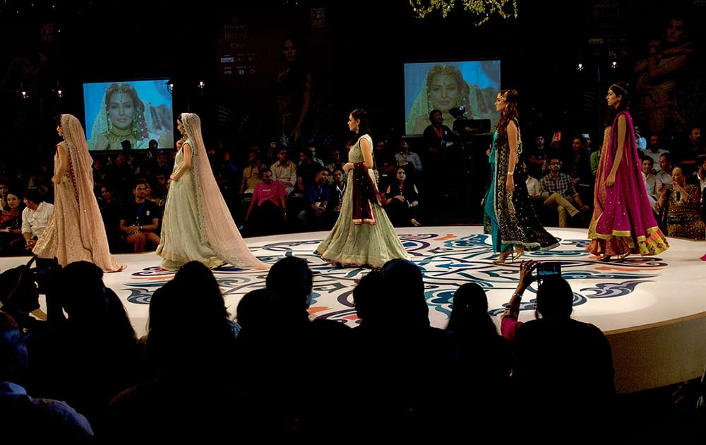 Models present creations by designer Sana Abbas during a Bridal Couture Fashion show in Karachi, Pakistan.