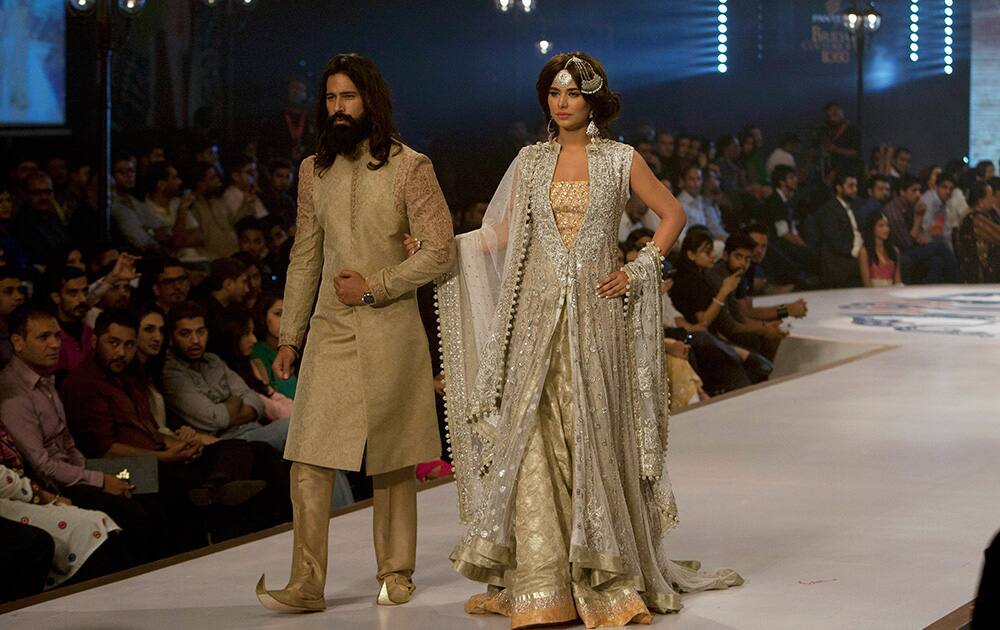 Models present creation by designer Sana Abbas during a Bridal Couture Fashion show in Karachi, Pakistan.