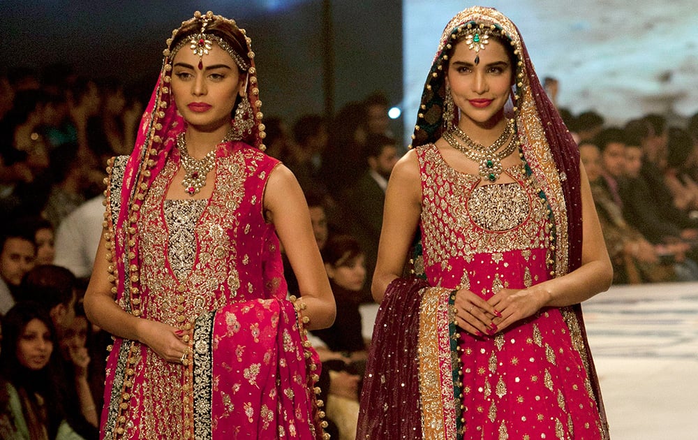 Models present creations by designer Zainb Chottani during a Bridal Couture Fashion show in Karachi, Pakistan.