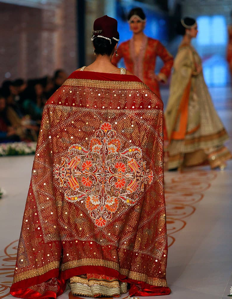 A model presents a creation by designer Deepak Perwani on the third day of the Bridal Couture Week in Karachi.