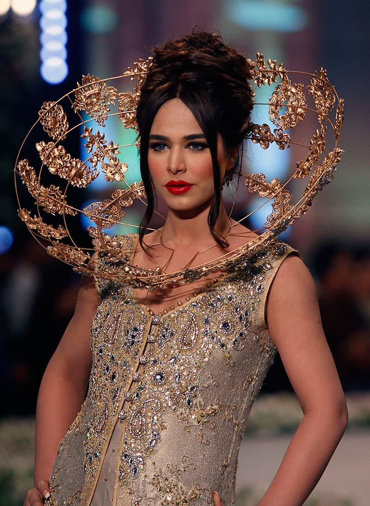 A model presents a creation by designer Tabassum Mughal on the third day of the Bridal Couture Week in Karachi.