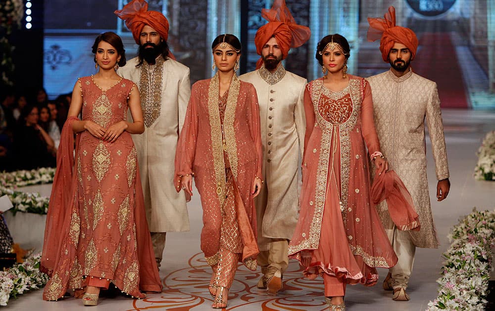 Models present creations by designer Nauman Arfeen on the third day of the Bridal Couture Week in Karachi.