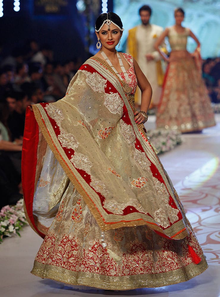 A model presents a creation by designer Deepak Perwani on the third day of the Bridal Couture Week in Karachi.