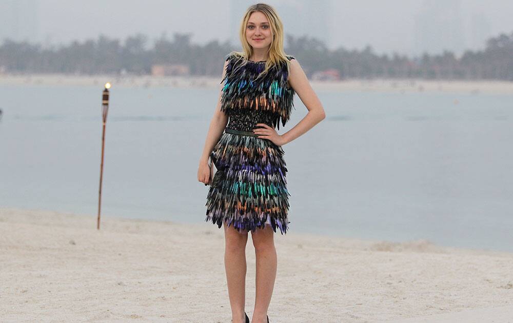 Actress Dakota Fanning poses for a photo as she arrives for the Chanel Cruise Dubai show revealing the French Maison's new Cruise collection of the 2014/15 season staged on a private island in Dubai, United Arab Emirates.