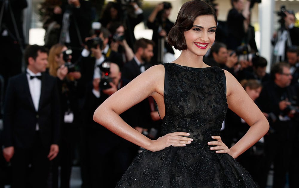 Actress Sonam Kapoor poses for photographers as she arrives for the screening of The Homesman at the 67th international film festival, Cannes, southern France.