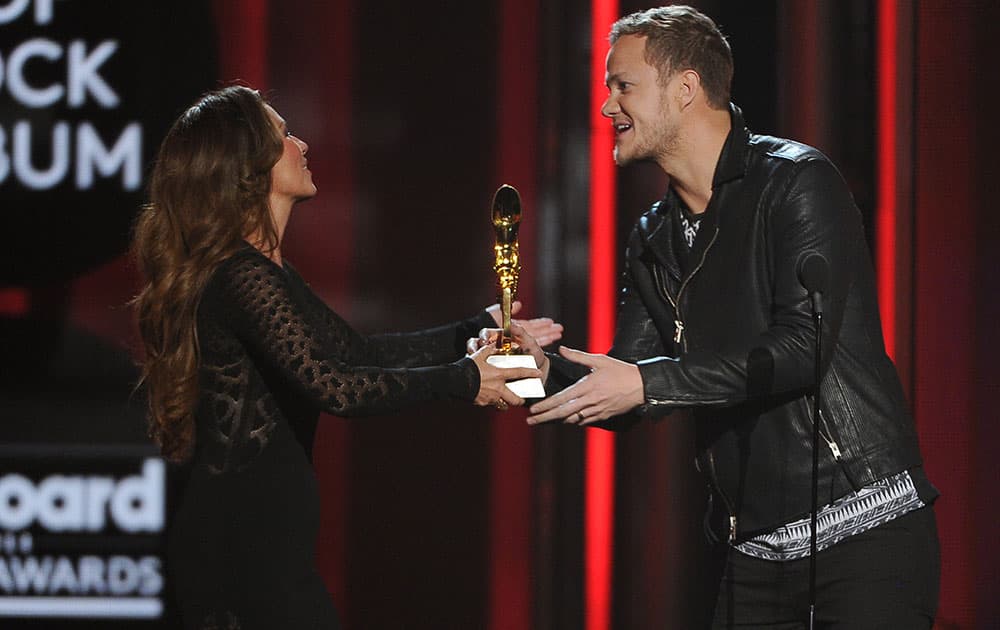 Shania Twain, left, presents the award for top rock album to Dan Reynolds, of the musical group Imagine Dragons, at the Billboard Music Awards at the MGM Grand Garden Arena.