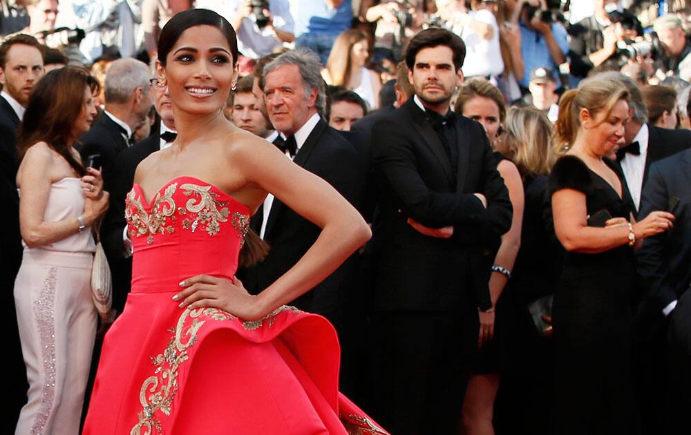 Actress Freida Pinto poses photographers as she arrives for the screening of The Homesman at the 67th international film festival, Cannes, southern France.