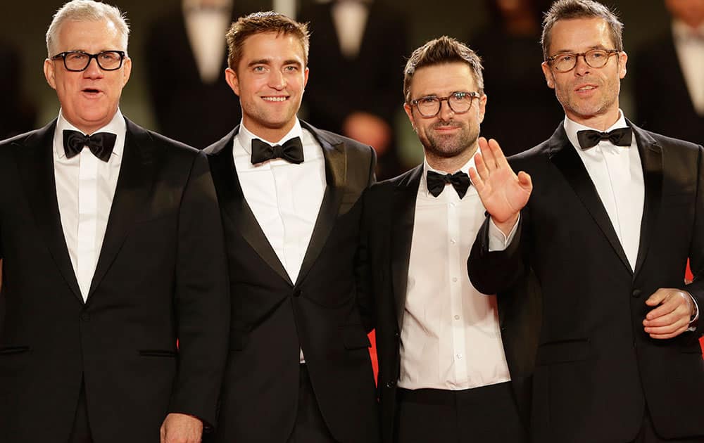 From left, producer David Linde, actor Robert Pattinson, director David Michod, and actor Guy Pearce pose for photographers as they arrive for the screening of The Rover at the 67th international film festival, Cannes.