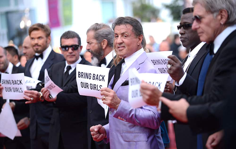 Actor Sylvester Stallone, center, stands with the cast of The Expendables 3, holding up banners reading, `Bring back our girls`, part of a campaign calling for the release of nearly 300 abducted Nigerian schoolgirls being held by Nigerian Islamic extremist group Boko Haram.