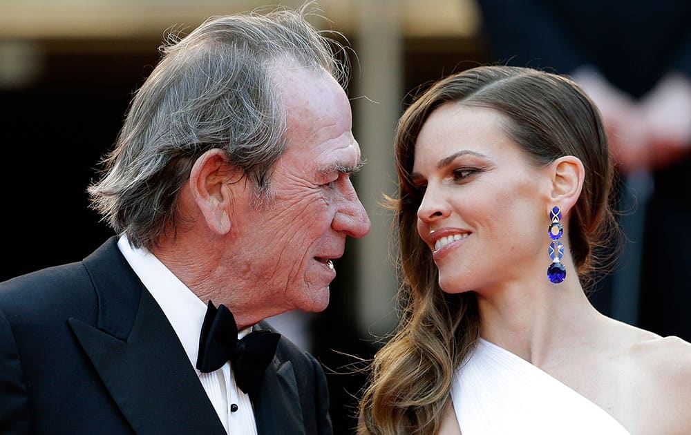 Director Tommy Lee Jones, left, and actress Hillary Swank speak as they arrive for the screening of The Homesman at the 67th international film festival, Cannes.