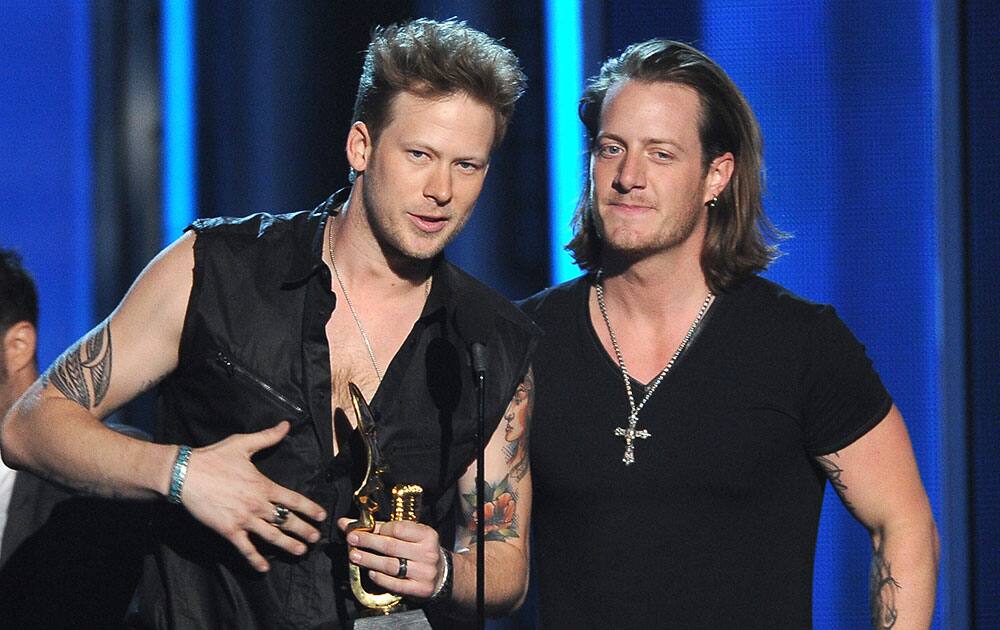 Brian Kelley, left, and Tyler Hubbard, of the musical group Florida Georgia Line, accept the award for top country song for `Cruise` at the Billboard Music Awards at the MGM Grand Garden Arena.