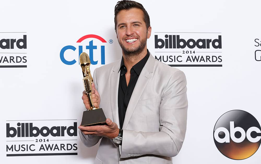 Luke Bryan poses in the press room with the award for top country artist at the Billboard Music Awards at the MGM Grand Garden Arena.