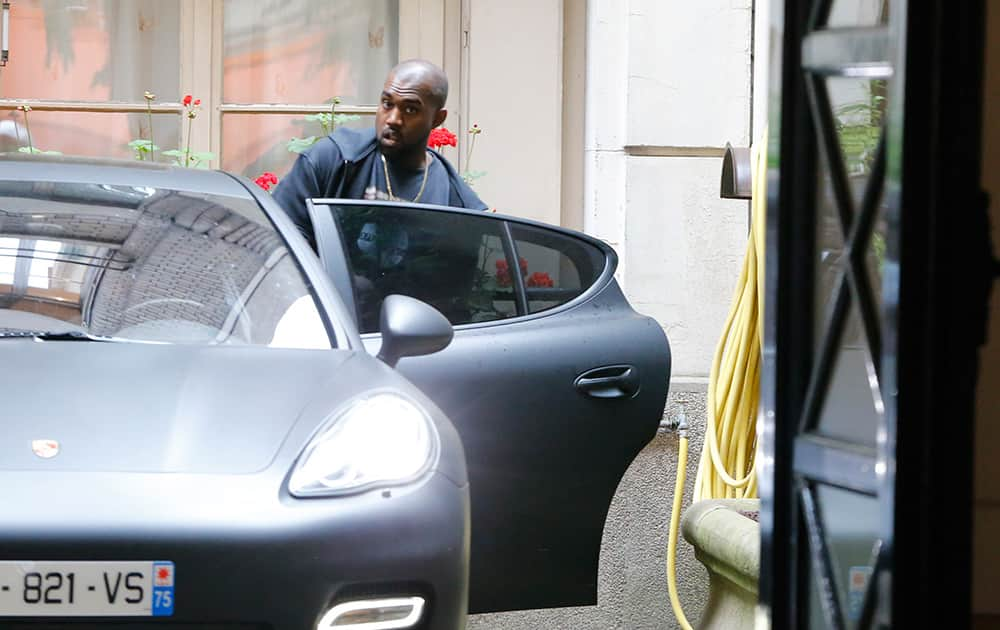 U.S rap singer Kanye West enters his car as he leaves a luxury shop in Paris. The gates of the Chateau de Versailles, once the digs of Louis XIV, will be thrown open to Kim Kardashian, Kanye West and their guests for a private evening this week ahead of their marriage. 