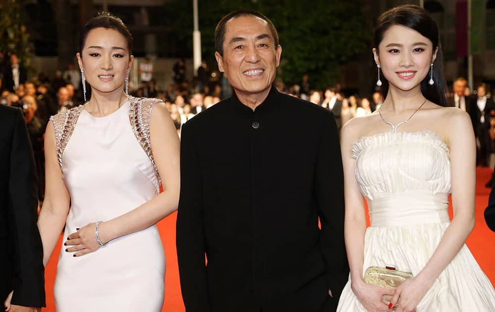 Actress Gong Li, director Zhang Yimou and actress Zhang Huiwen arrive for the screening of Coming Home (Gu Lai) at the 67th international film festival, Cannes, southern France.