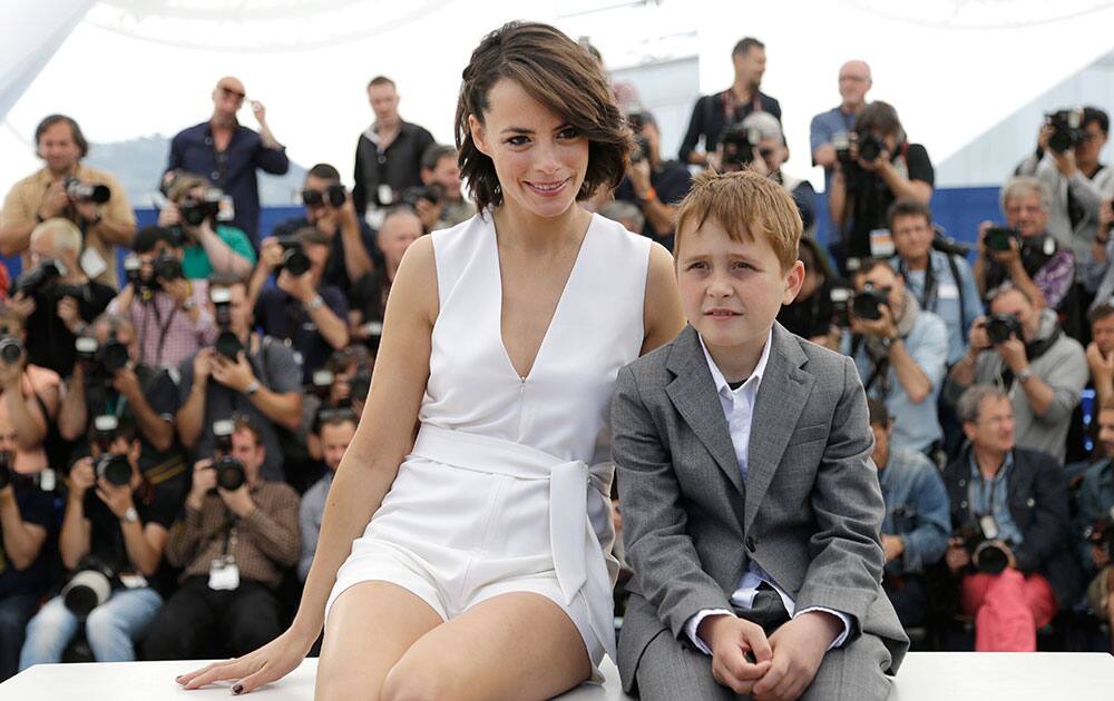 Actress Berenice Bejo, left, and actor Abdul Khalim Mamatsueiv pose for photographers during a photo call for The Search at the 67th international film festival, Cannes, southern France.