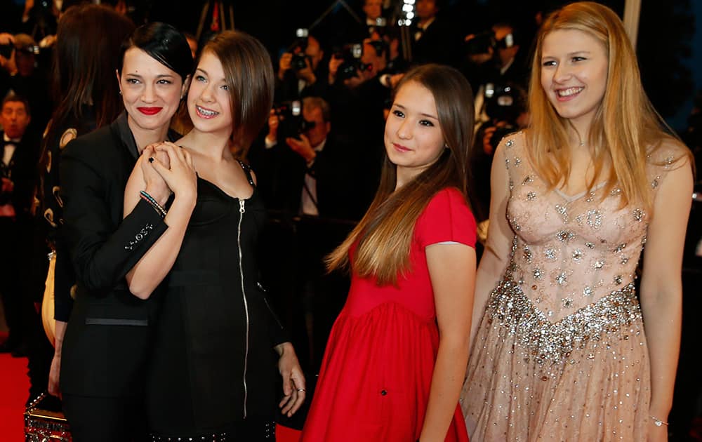 Director Asia Argento, left, and cast members of Misunderstood pose for photographers as they arrive for the screening of Mommy at the 67th international film festival, Cannes, southern France.