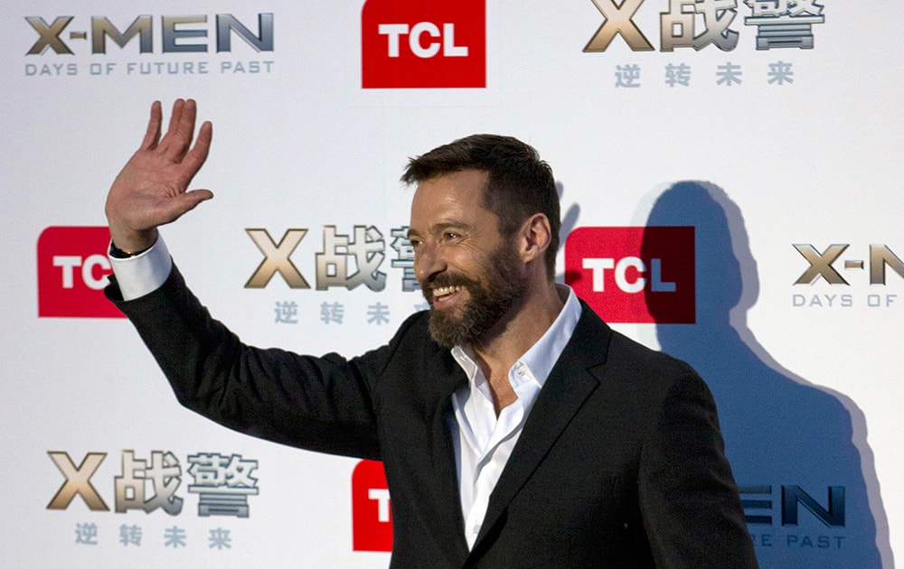 Australian actor Hugh Jackman waves as he arrives at the red carpet for his latest movie 'X-Men:Days of Future Past' in Beijing, China.