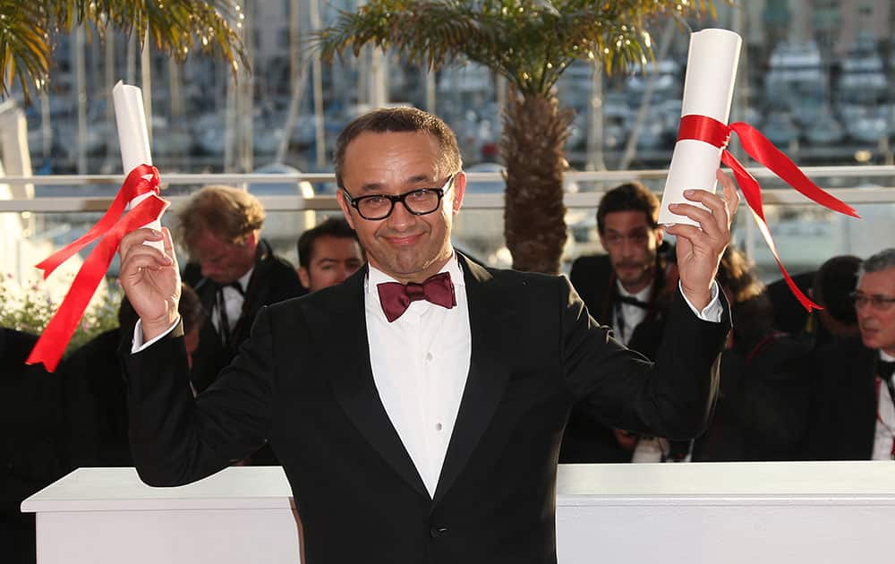 Director Andrey Zvyagintsev poses after his film won the Best Screenplay award for the film Leviathan during a photo call following the awards ceremony at the 67th international film festival, Cannes.