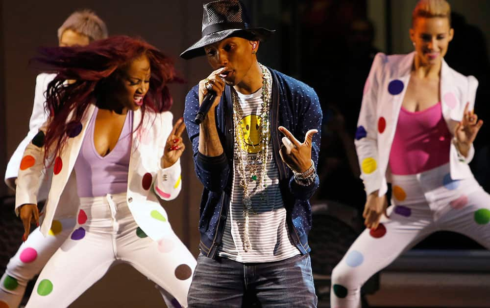 Singer Pharrell Williams performs on stage during a private concert for the exhibition `GIRL` at the Perrotin Gallery in Paris.