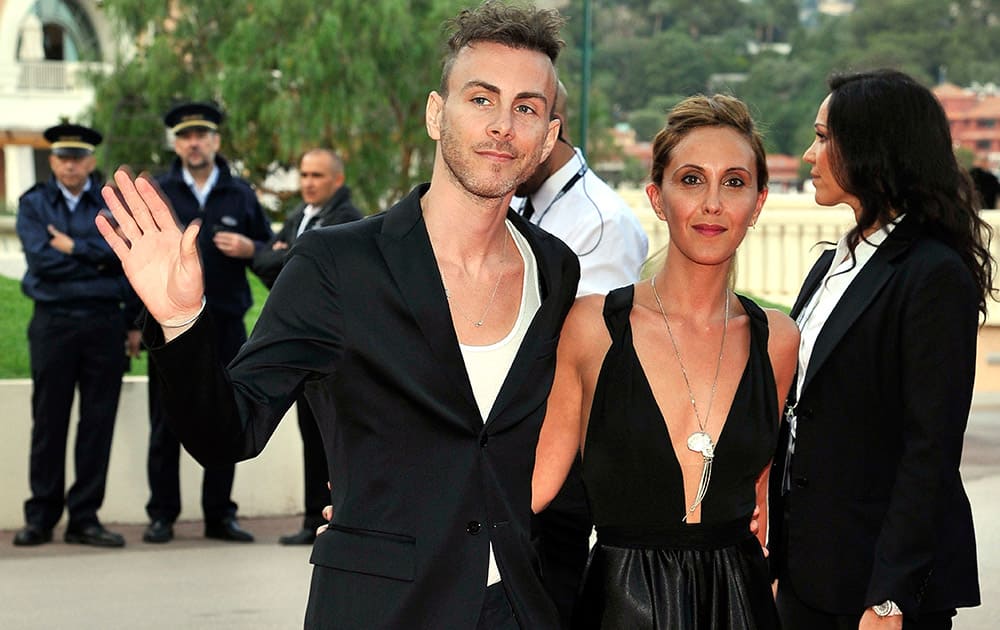 Israeli singer-songwriter and musician Asaf Avidan, left, and companion waves as they arrive for the World Music Awards in Monaco.